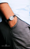 Iconic silver lion logo with genuine leather.