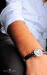 Iconic silver lion logo with genuine leather.